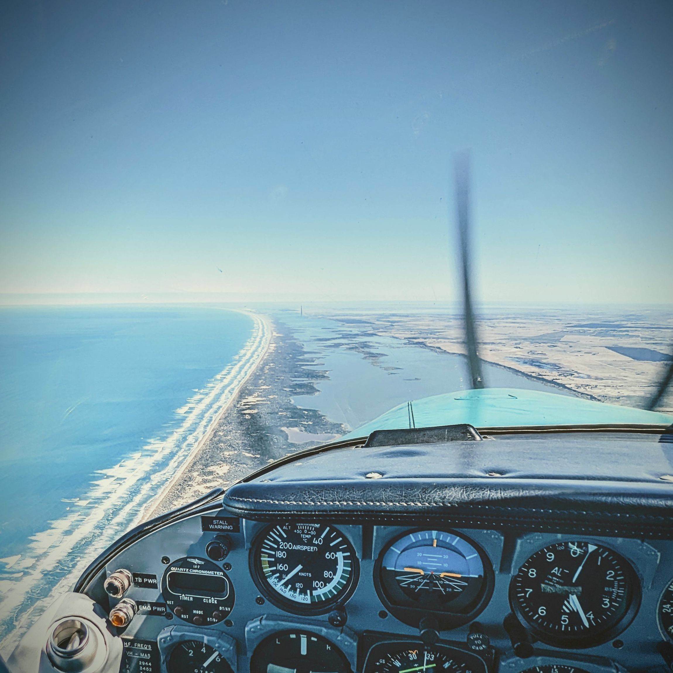 Cockpit view over Australian coastline during aerial survey