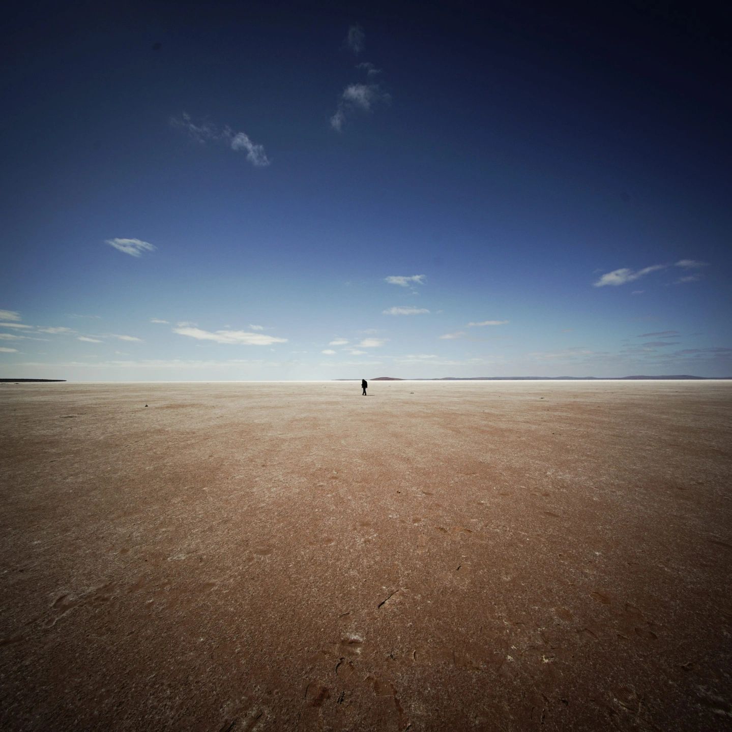 Lone figure on a vast Australian salt lake